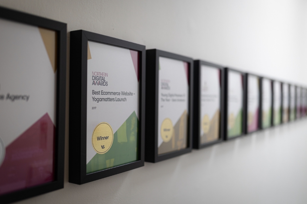 Awards in frames on a wall