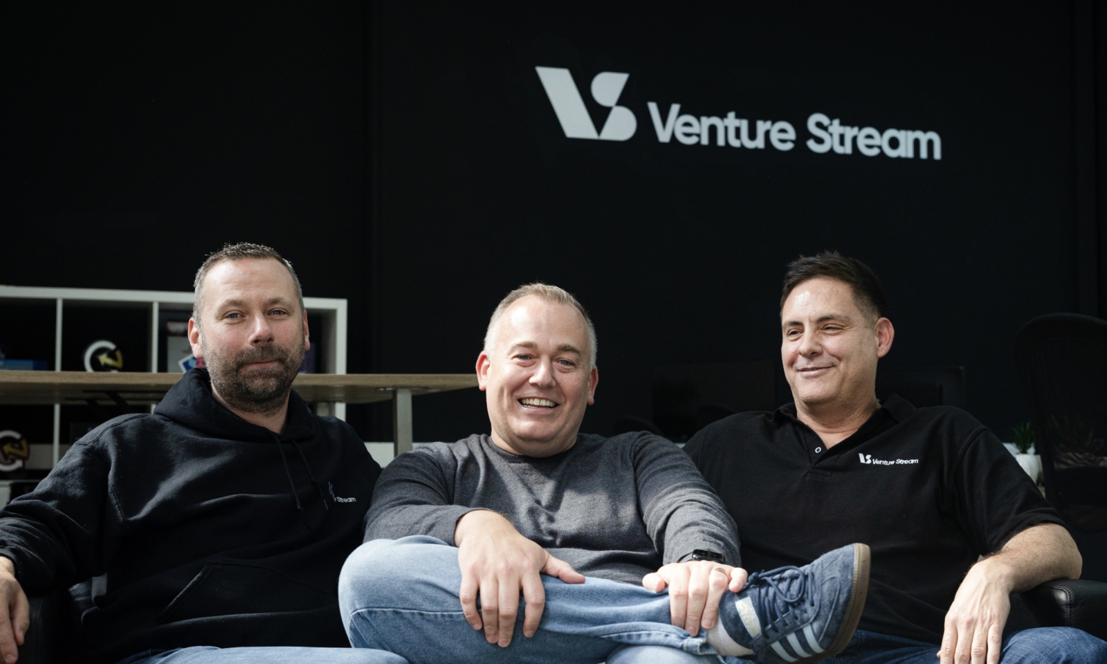 Leaders James Chapman, Andy Robinson, and Vic Morgan smiling on a sofa